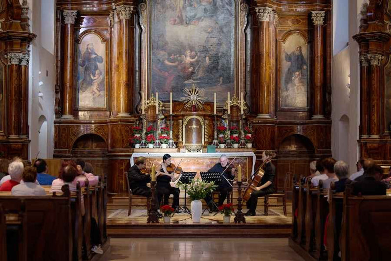 String quartet performing in front of the altar at Capuchin Church Vienna